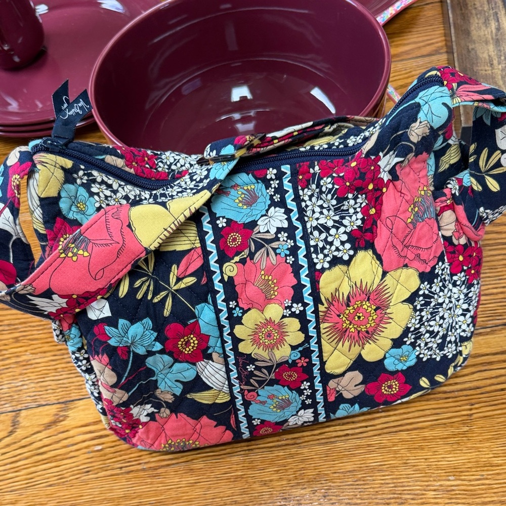 Vera Bradley  On the Go style shoulder bag in the “Happy Snails” pattern.